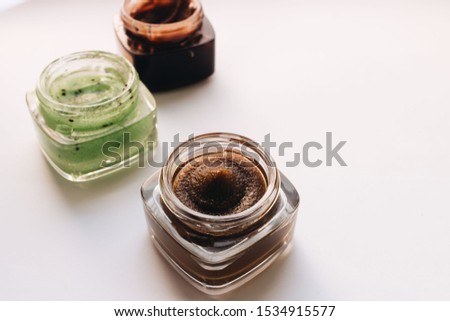 Chocolate cream in small jar on white background