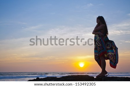 beautiful girl relaxes on background of ocean, bali, indonesia