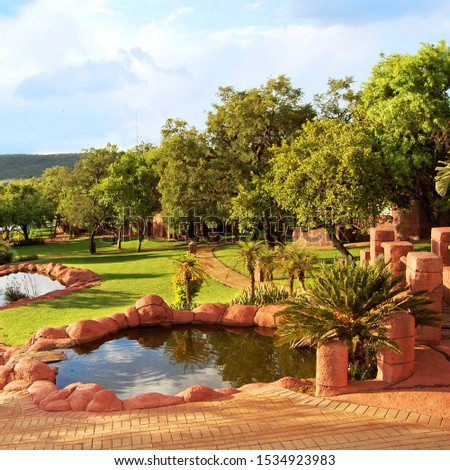 Beautiful African landscape of a lodge with a nice garden and lakes. Everything for your relaxation in a guesthouse. Amazing view. Travel & Vacation Awesome lodge in Africa.