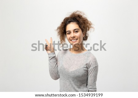 Beautiful young woman portrait. Indoor portrait of beautiful brunette young woman with shaggy hairstyle.