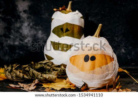 Zombie pumpkins in bandages, on a dark background. The concept of Halloween.