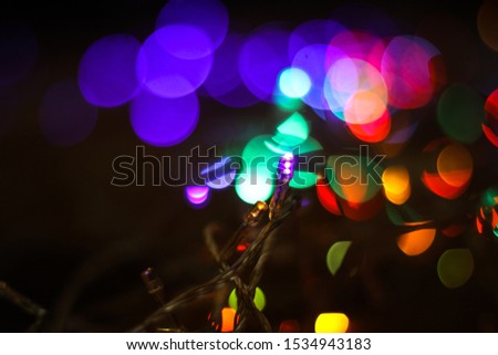 Beautiful Christmas background with garlands and bokeh. New year  multi-colored picture. Abstract photo image for design