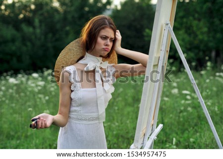 woman model happy outdoors easel with canvas