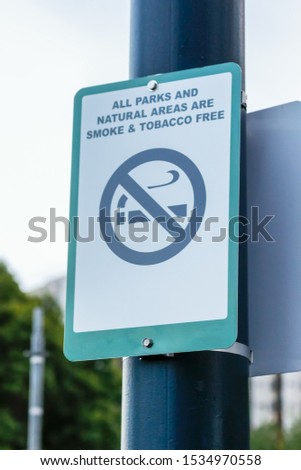 No Smoking area warning sign in the park Stuck on a pole.