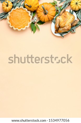 Thanksgiving dinner invitation concept or mock up, top down view on autumn traditional food decorated with pumpkins and sage
