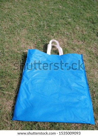 isolated of blue color bag on green grass