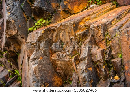 Strata of foliated homogeneous metamorphic rock derived from sedimentary rock.They  form from tectonic processes as continental collisions, which cause horizontal pressure, friction & distortion.

 Royalty-Free Stock Photo #1535027405