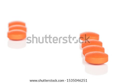 Group of seven whole orange tablet pharmacy isolated on white background
