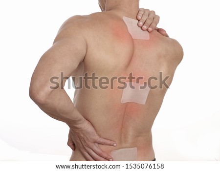 Medicated pain relief patch, plaster. man with back pain. Pain relief and health care concept isolated on white. Royalty-Free Stock Photo #1535076158