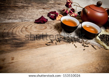 Tea cups with teapot on old wooden table. With place for text.