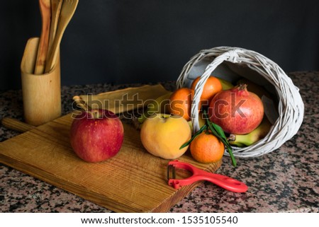 Stock photo of a fruit still live with a white basket and black background. Health, food