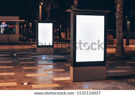 Street advertising mockup template with copy space. Two outdoor commercial banners with white empty display on the night street