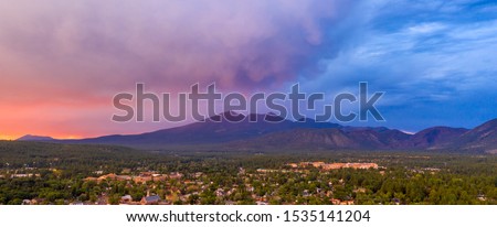Blue and Orange color swirls around in the clouds at sunset over Flagstaff Arizona Royalty-Free Stock Photo #1535141204