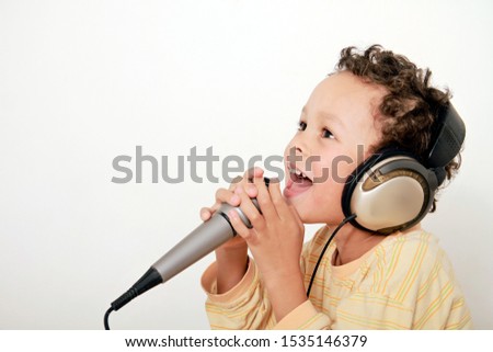 boy with headphones enjoying DJ music with microphone on white background stock photography stock photo