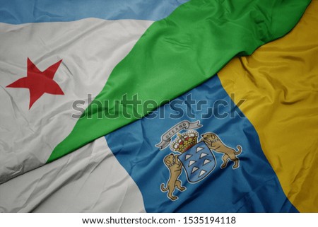 waving colorful flag of canary islands and national flag of djibouti. macro