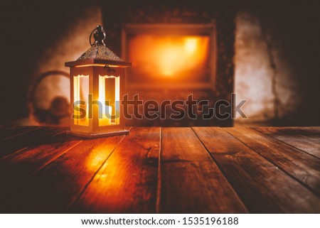 Wooden top with cosy warm home interior with fireplace background and wooden top for advertising products and decorations.