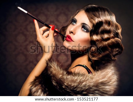 Retro Woman Portrait. Beautiful Woman with Mouthpiece. Cigarette. Smoking Lady. Vintage Styled Black and White Photo. Old Fashioned Makeup and Finger Wave Hairstyle. 20's or 30's style.  Royalty-Free Stock Photo #153521177