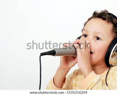 boy with headphones enjoying DJ music with microphone on white background stock photography stock photo