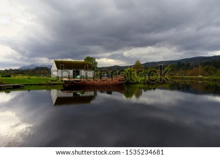 Rusting hulk moored in the Caledonian Canal at Fort Augustus Scotland                                Royalty-Free Stock Photo #1535234681
