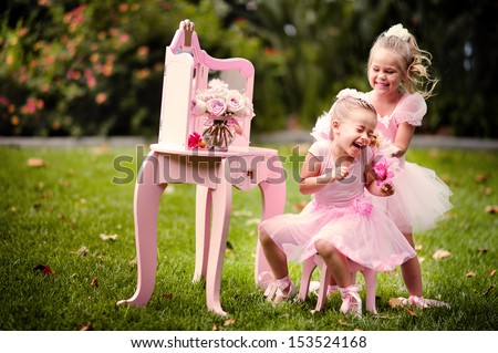 two happy little girl wearing in princess costumes have a fun in a beautiful garden Royalty-Free Stock Photo #153524168