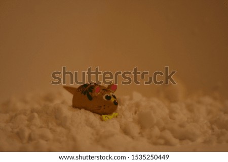 toy mouse crawling in the snow