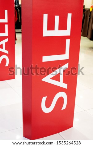 The inscription sale at the entrance to the store in the mall. Red background and white letters. Discounts and trade