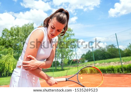 Elbow injury in tennis, unpleasant facial expression, arm injury Royalty-Free Stock Photo #1535269523