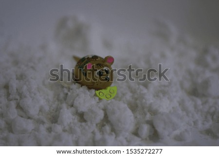 toy mouse with cheese in the snow