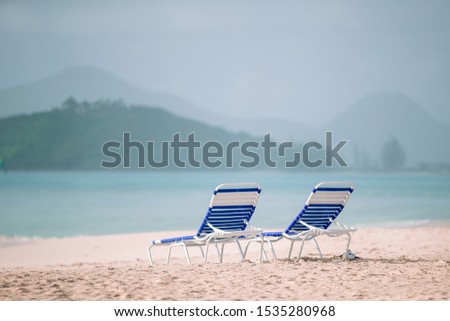 Beach lounge chairs on beautiful tropical beach at Maldives