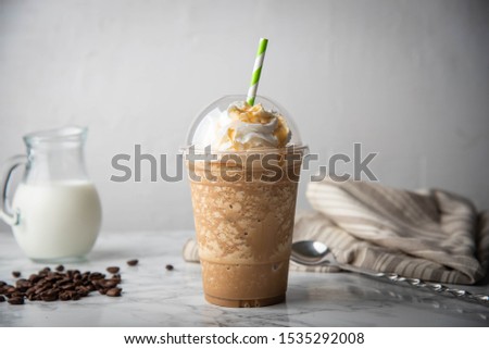 caramel frappe with wipped cream on marble table  Royalty-Free Stock Photo #1535292008