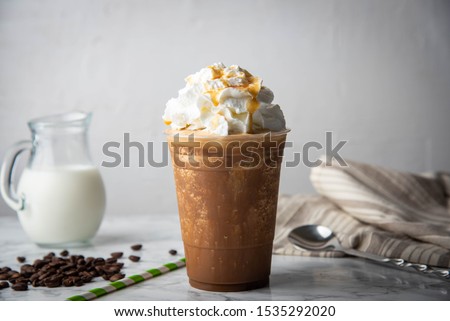 caramel frappe with wipped cream on marble table  Royalty-Free Stock Photo #1535292020