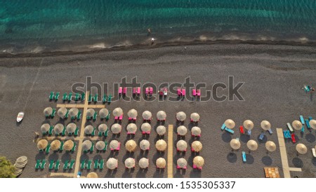 Aerial drone top down photo of organised with sun beds and umbrellas Mediterranean colourful sandy beach with deep turquoise sea