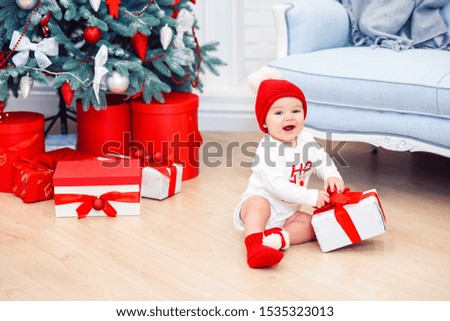 Charming toddler boy holds christmas gift box. Concept of Christmas holidays.