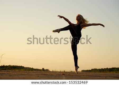 Professional gymnast woman dancer posing on concrete road