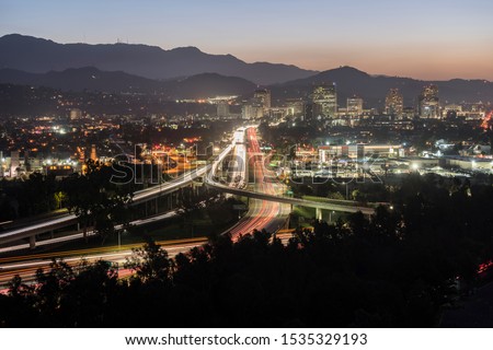 Dawn view of commuters on the Route 134 Ventura freeway in Glendale and Los Angeles, California.  Shot from Griffith Park looking east towards the San Gabriel Mountains.