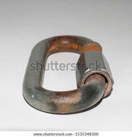 well rusted metal carabiner on white background