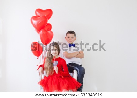 Girl and boy with balloons on Valentine's Day