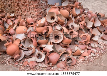Pile of broken clay pots or earthenware or traditional jar on a abandoned road.	