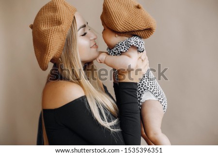 Mother with cute daughter. Blonde with long hair. Little child in a stylish clothes
