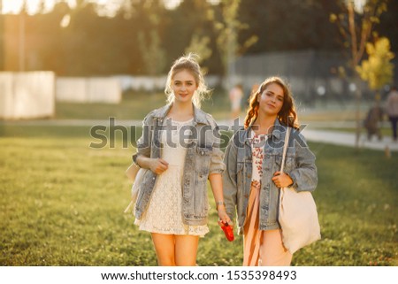 Girl in a blue jacket. Women in a summer park. Woman with ared flood
