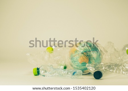 A globe in a plastic bag and plastic around. Plastic and globe in the concept of global environment from plastic.