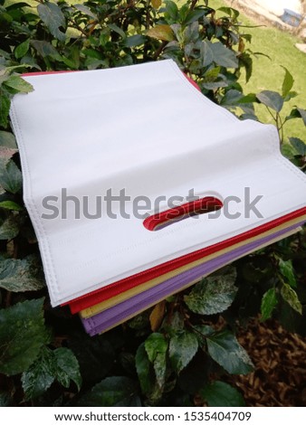 non woven eco bags on beautiful green plant leaves 