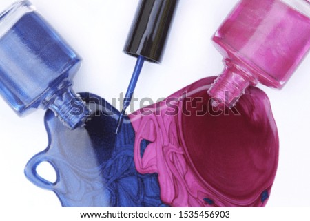 Pink and Blue Spilled Nail Polish on white background