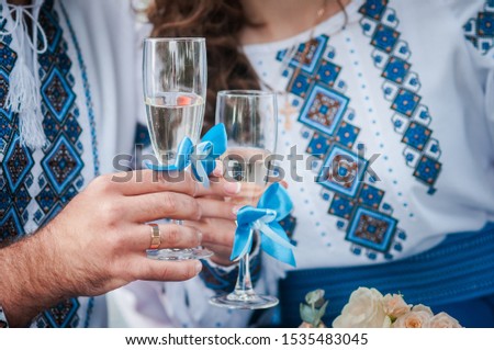 bride and groom clink glasses with champagne