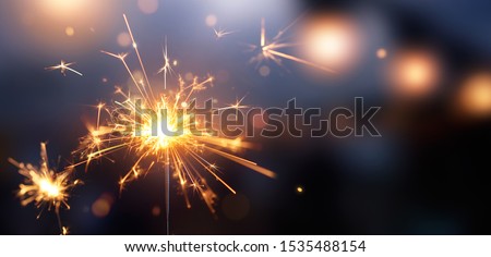 Happy New Year, Glittering burning sparkler against blurred bokeh light background Royalty-Free Stock Photo #1535488154