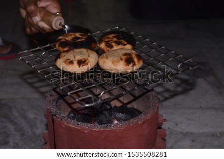 Homemade bihari Litti baked on traditional coal stove fire