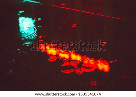 the reflection of headlights on wet asphalt night abstract background 