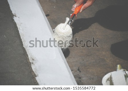 Painting white colour street sign footpath.