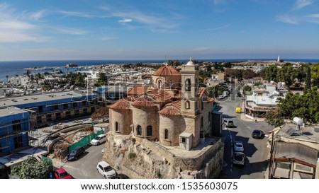 Church of Panagia Theoskepasti aerial photo in Kato Paphos, Cyprus. This seaside church founded in 10th century is unique beautiful city sign. Orange roof and marvel walls, looks gorgeous. 
