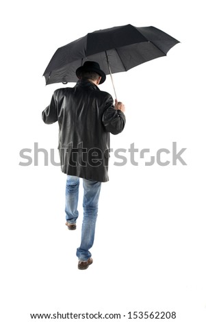 Man with black umbrella walking on a white background back to the camera